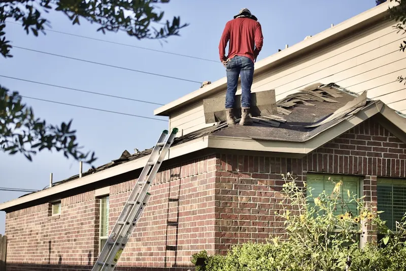 Professional roofer working on a residential roof in Rhome